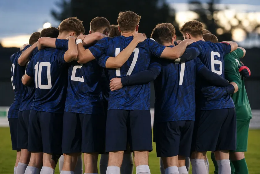 Fußballteam von hinten in bedruckten Trikots mit Rückennummern